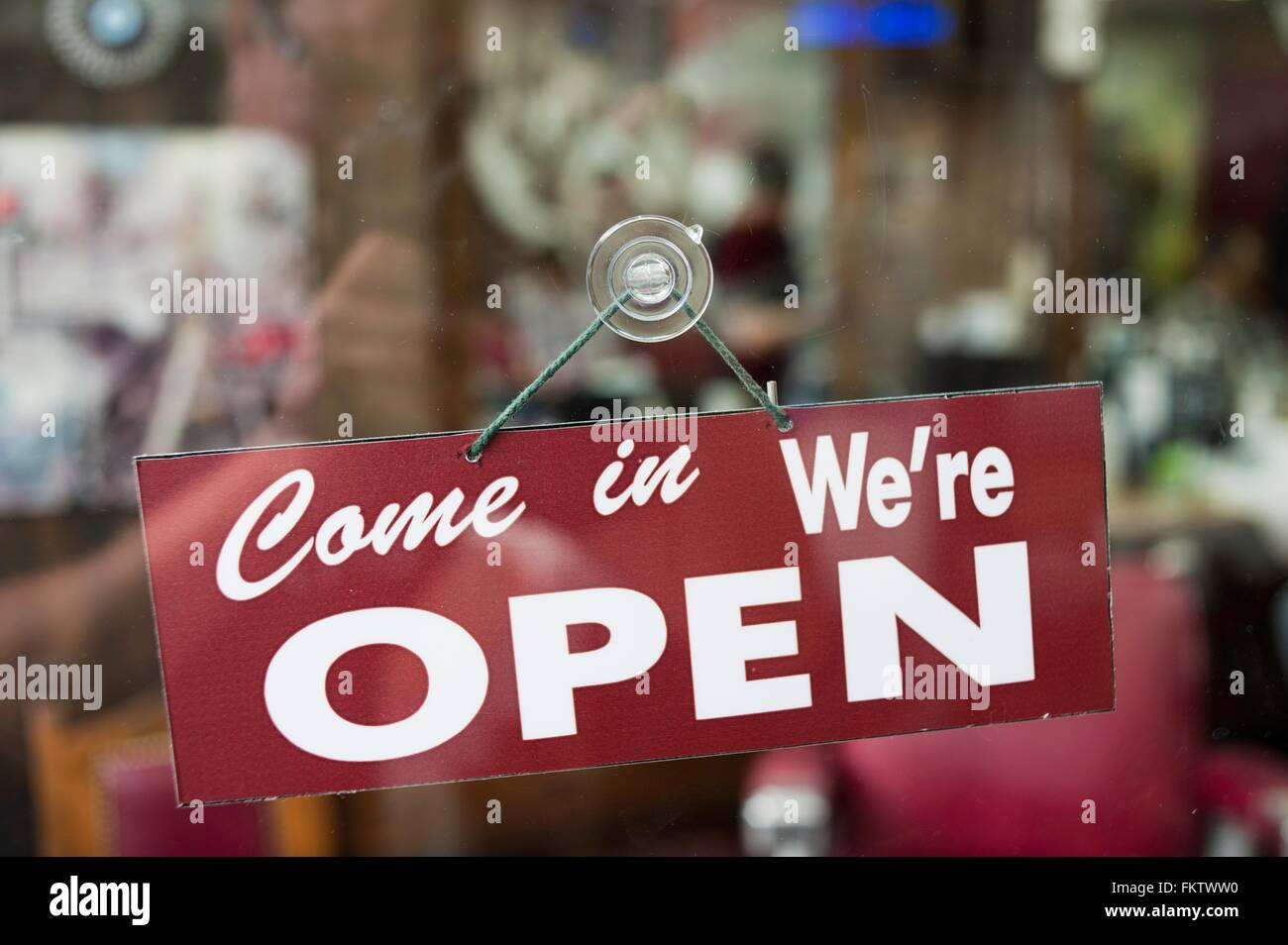View through window of open sign in shop Stock Photo