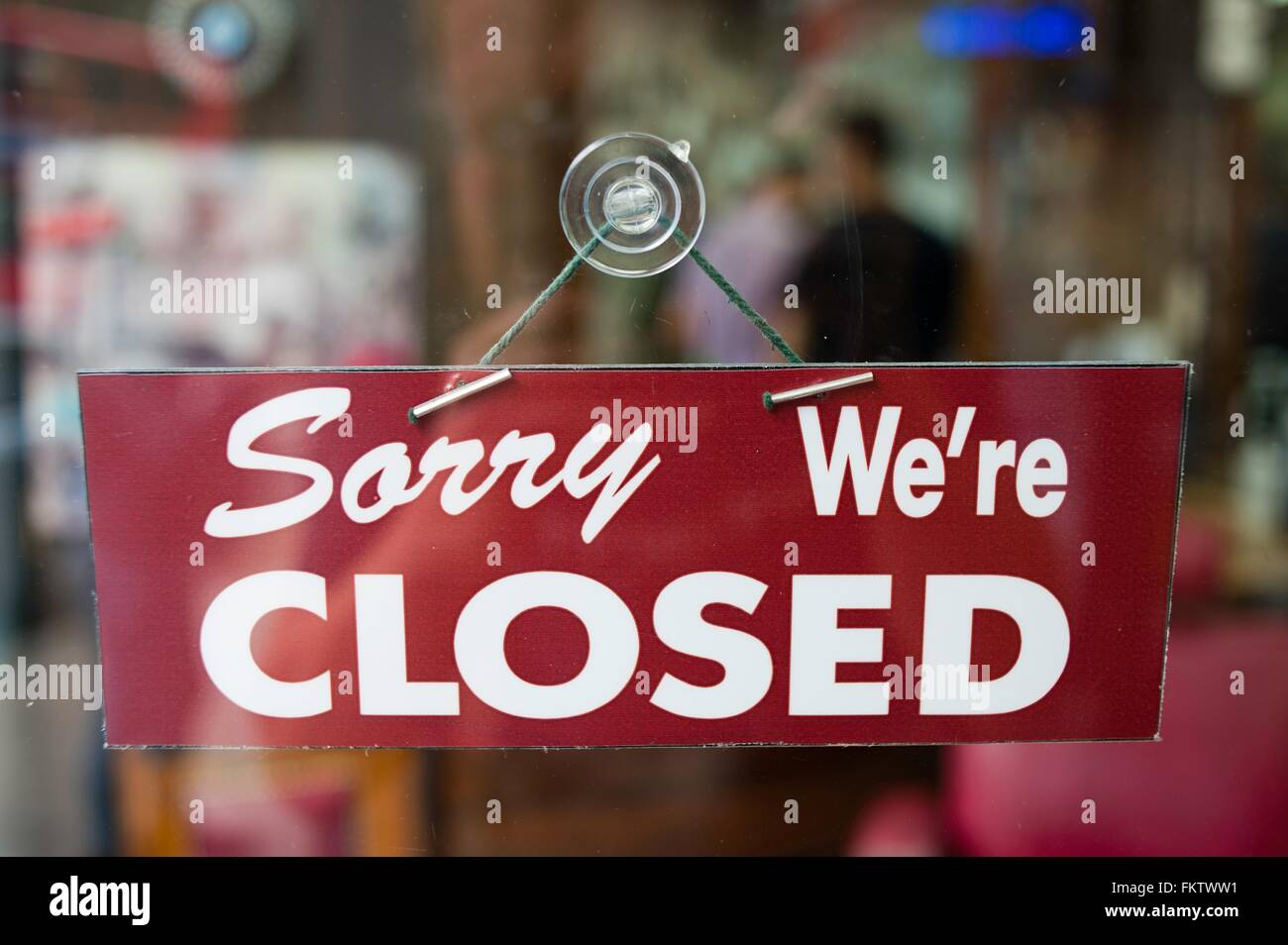 View through window of closed sign in shop Stock Photo