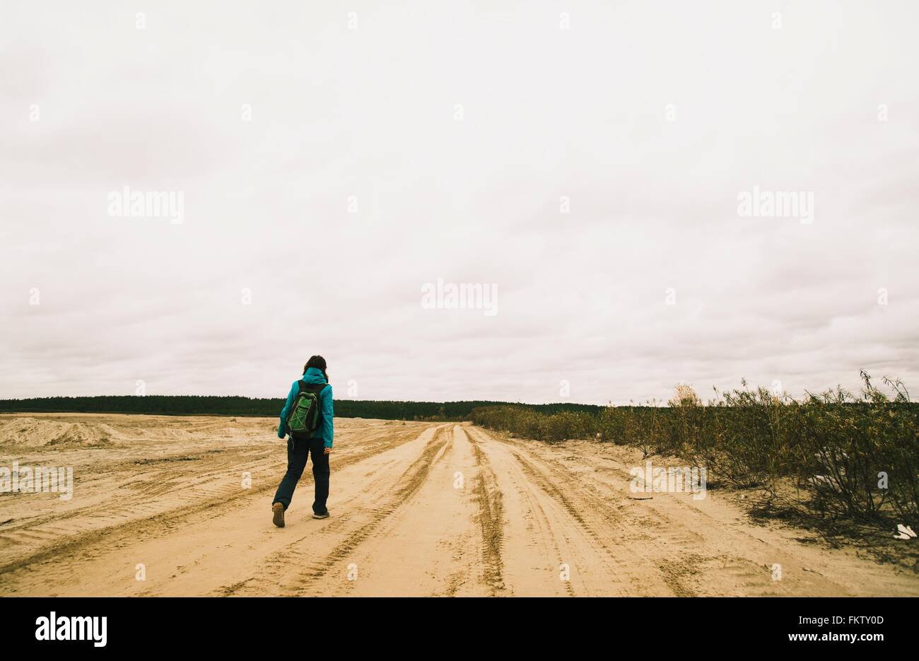 Young woman hiking along dirt road, rear view Stock Photo - Alamy