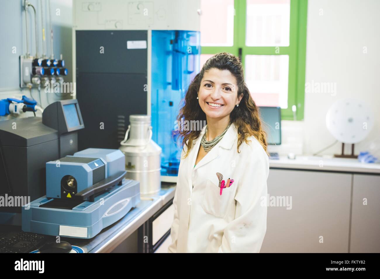 Female scientist and Thermogravimetric/Differential Thermal Analyzer Stock Photo