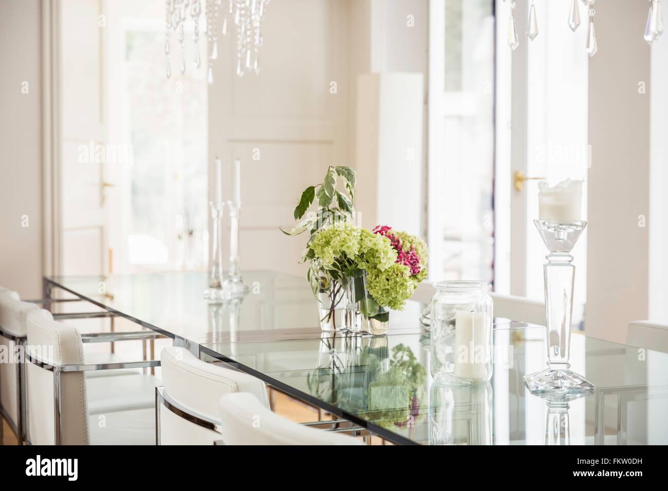 Stylish dining room with glass topped table and glass candlesticks