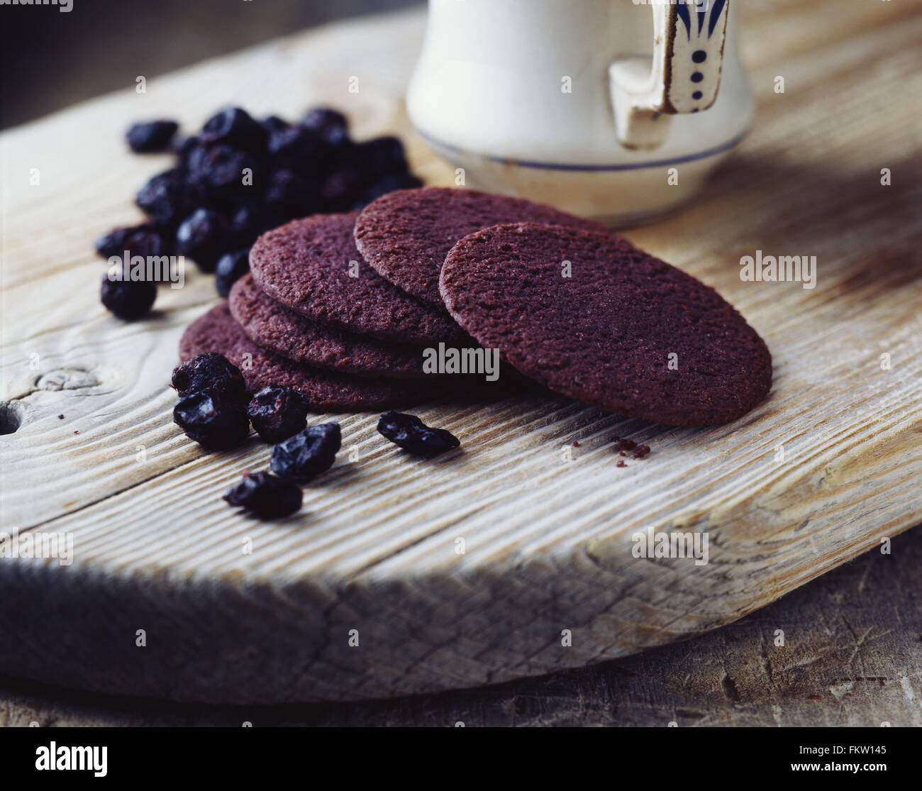 Luxury blackcurrant thins on vintage wooden cutting board Stock Photo