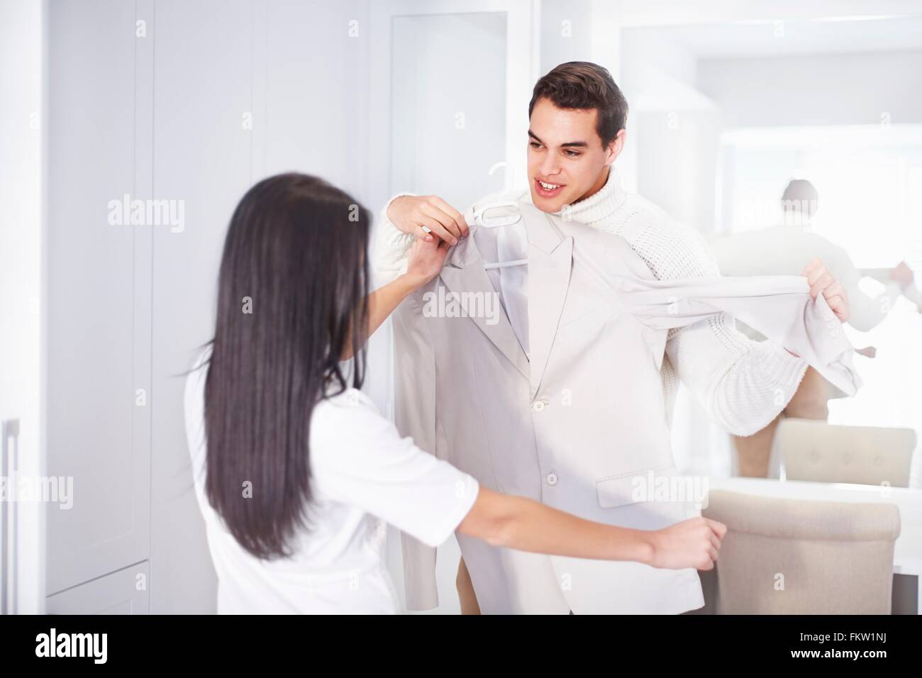 Young couple getting ready together in bedroom Stock Photo