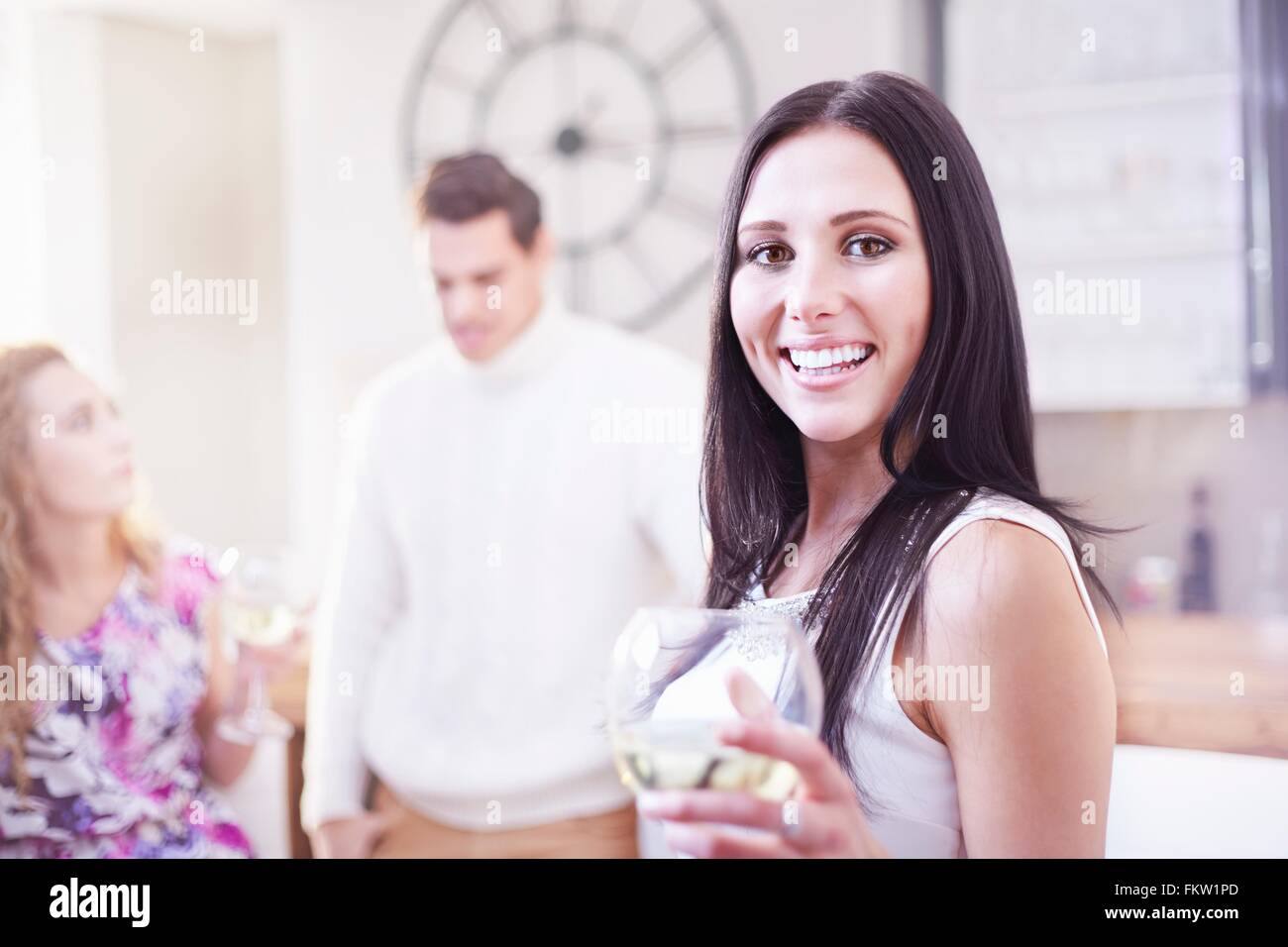 Portrait   young woman drinking wine in kitchen Stock Photo