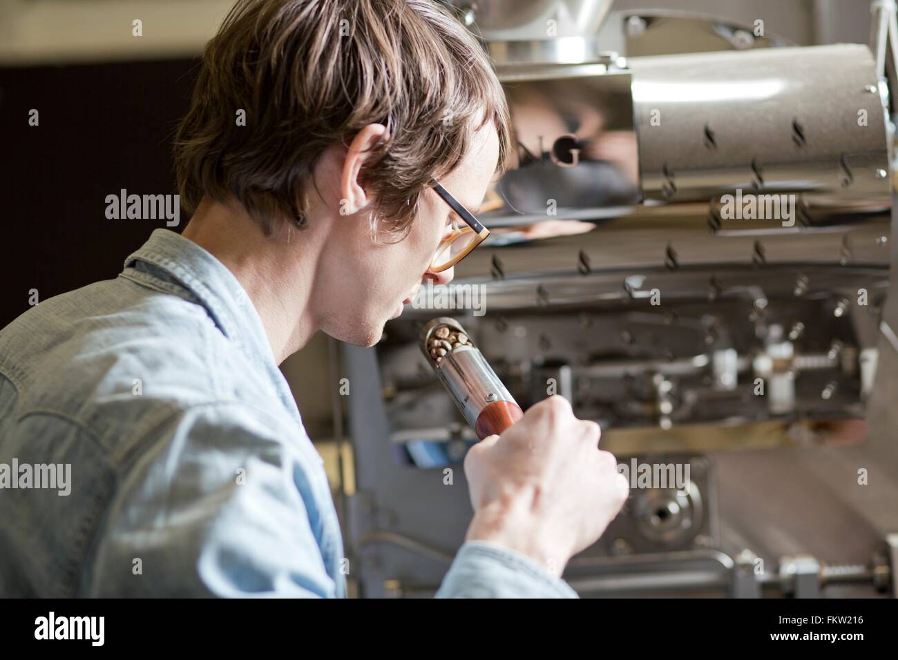 C fee business owner sniffing c fee beans Stock Photo