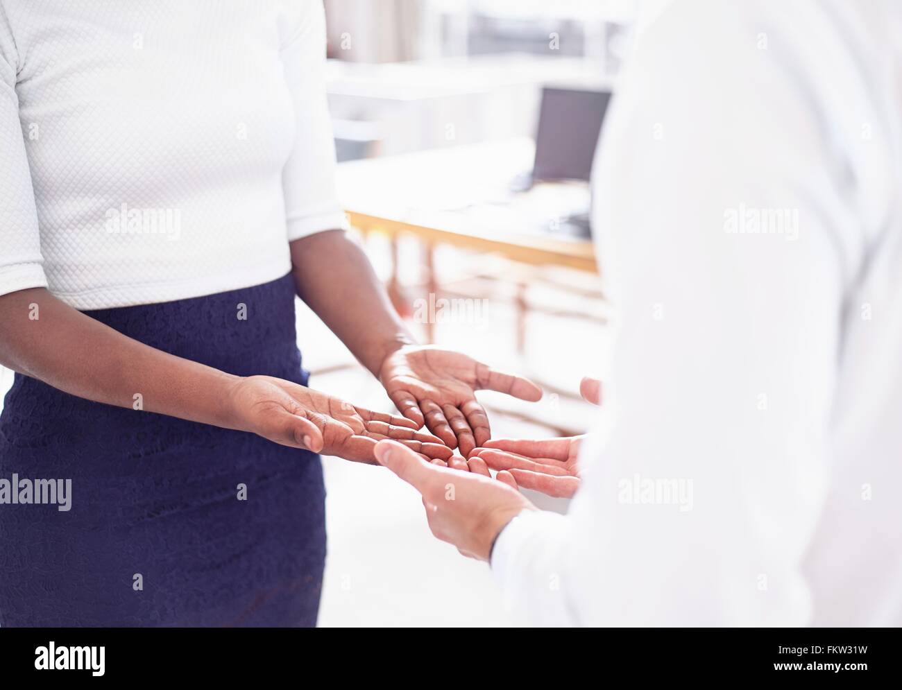 Cropped view   couple face to face, open hands together Stock Photo