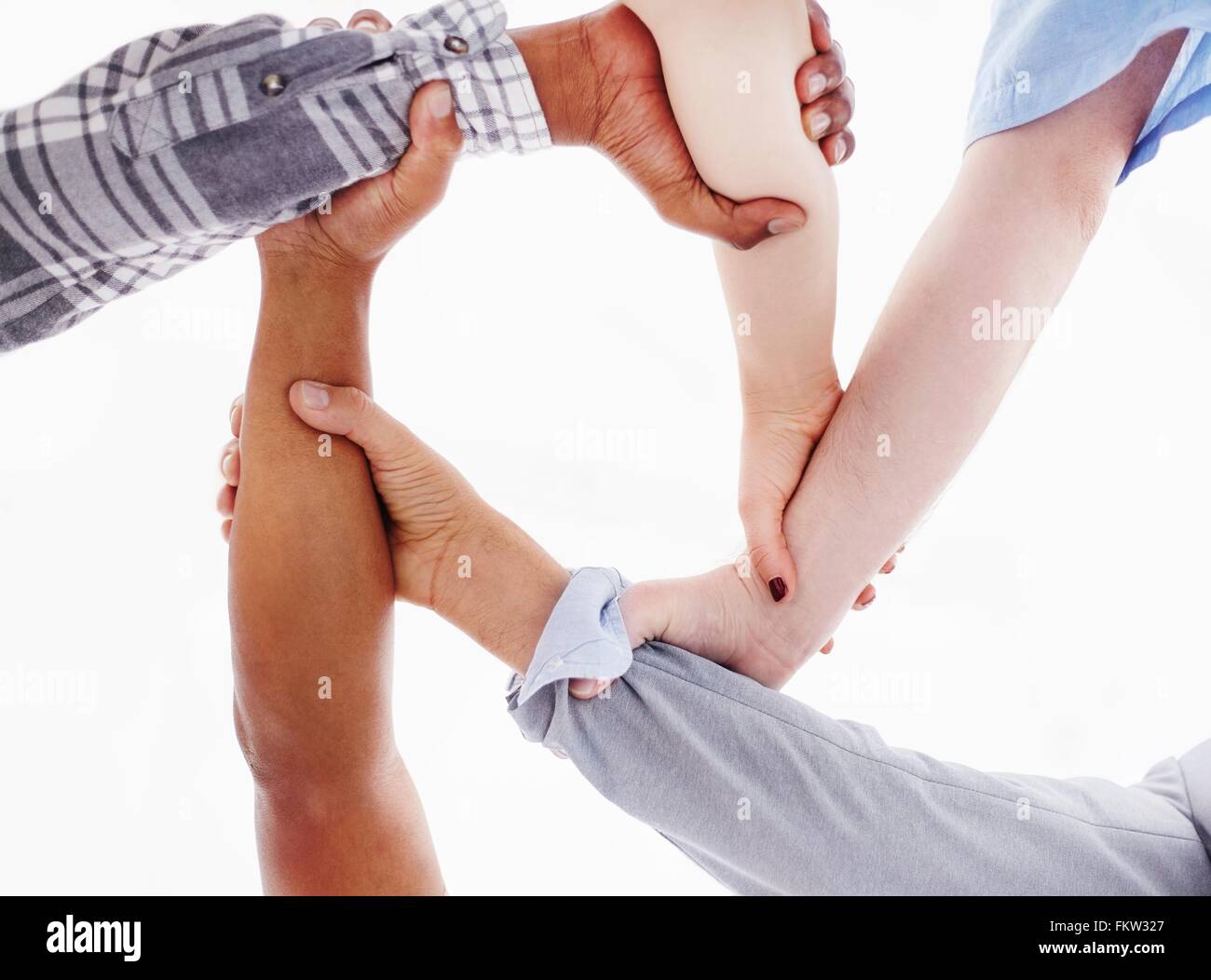 View from below   people holding wrists Stock Photo