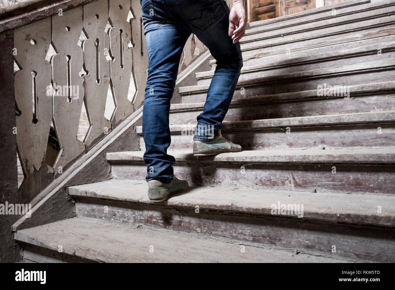 Man going up staircase Stock Photo Alamy