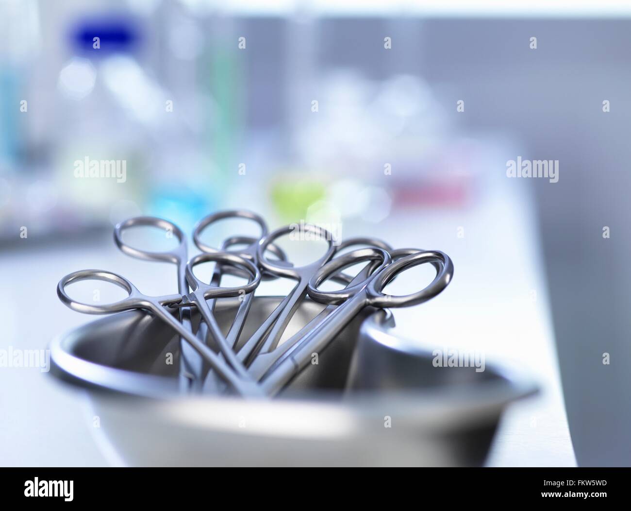 Kidney-shaped tray with surgical scissors Stock Photo