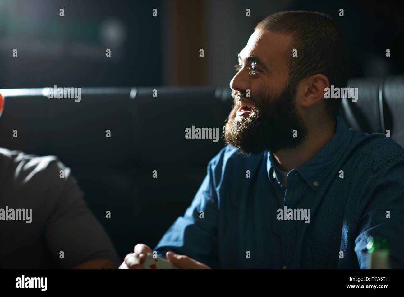 Man shuffling playing cards in traditional UK pub Stock Photo