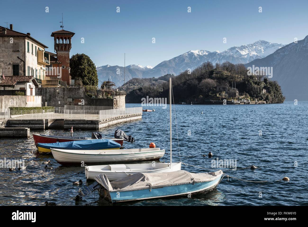 Boats anchored near lakeside villa, Lake Como, Italy Stock Photo