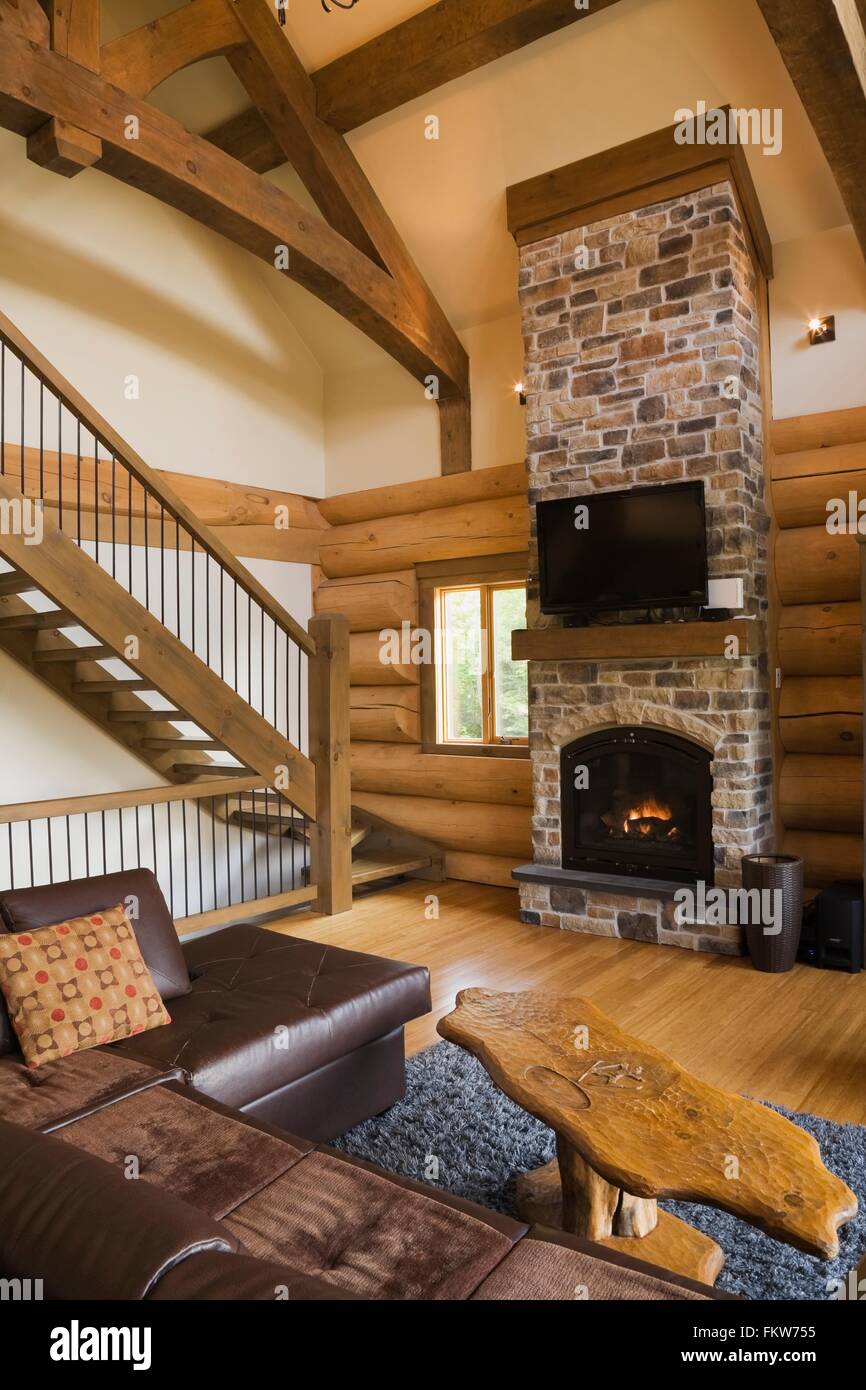 Living Room With Leather Sofa And Coffee Table In Front Of Stone