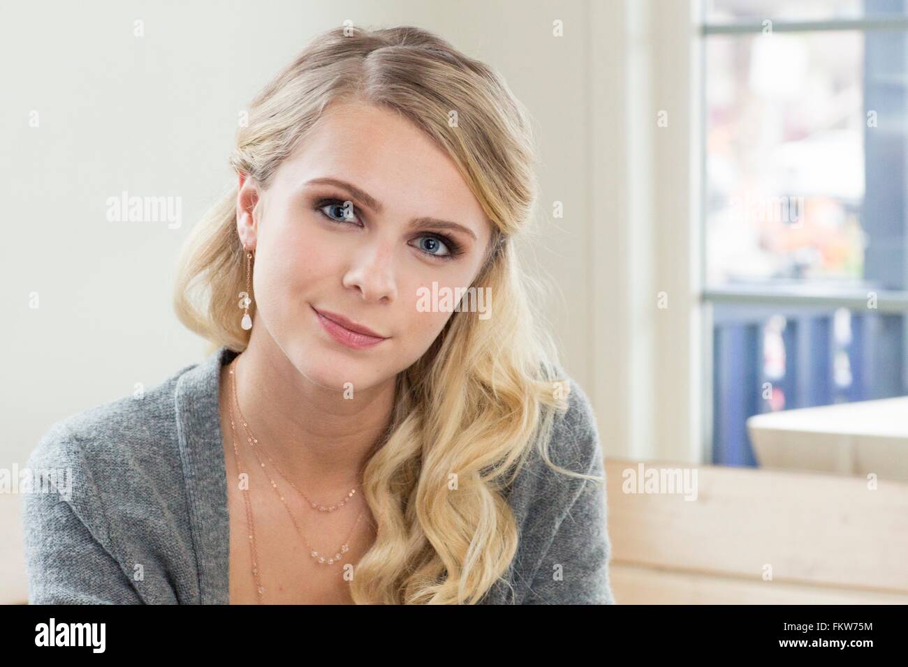 Portrait of young blonde haired woman looking at camera smiling Stock ...