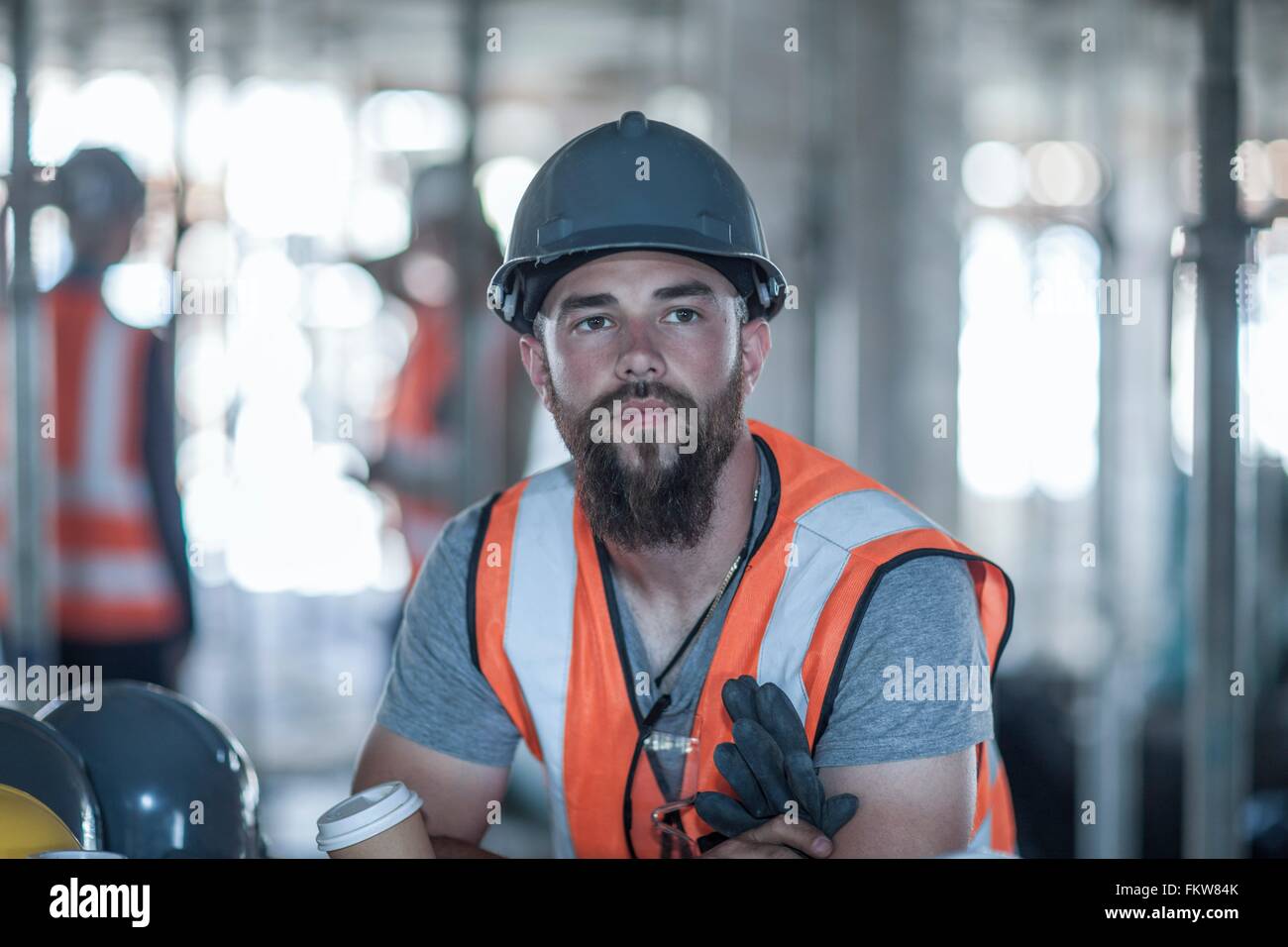 Builder taking a coffee break on construction site Stock Photo