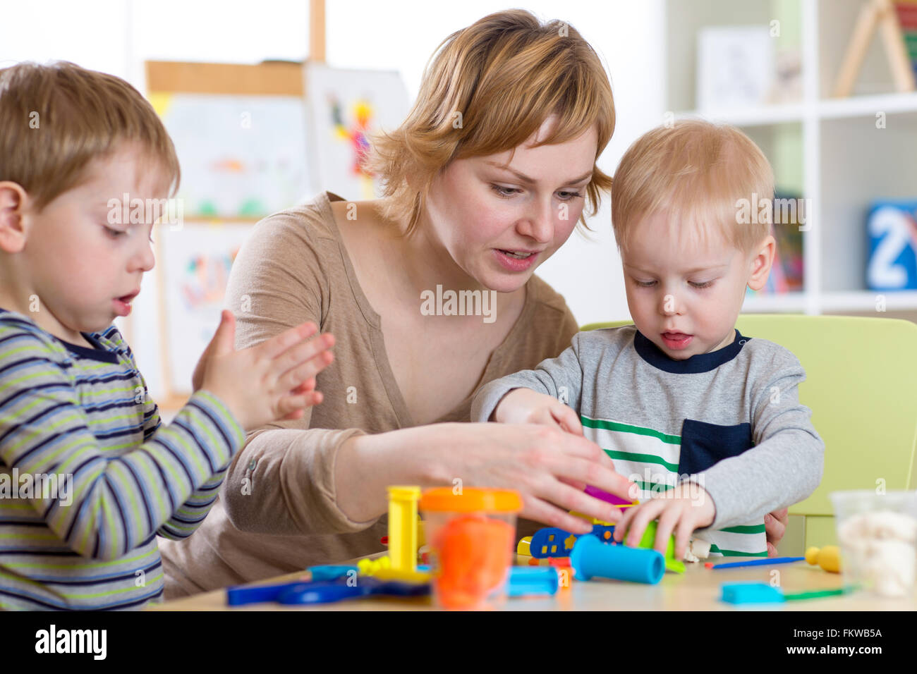 woman teaches kids handcraft at kindergarten or playschool Stock Photo