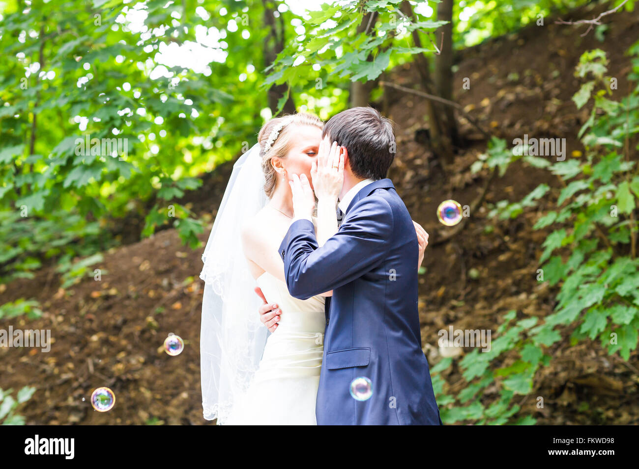 Wedding, Beautiful Romantic Bride and Groom Kissing Stock Photo - Alamy