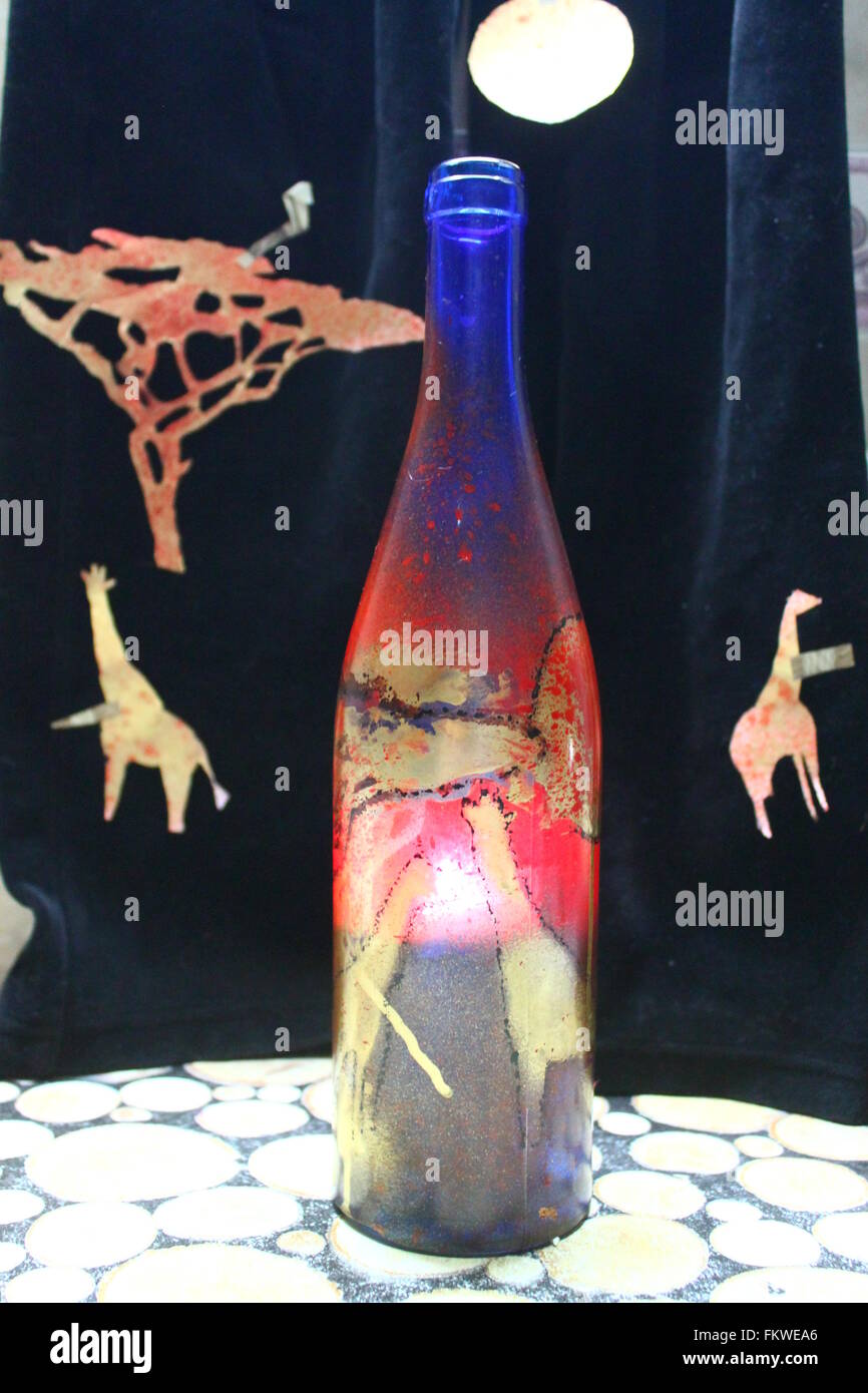 bottle  under wine with picture of African savanna on made like lampshade with burn candle inside Stock Photo