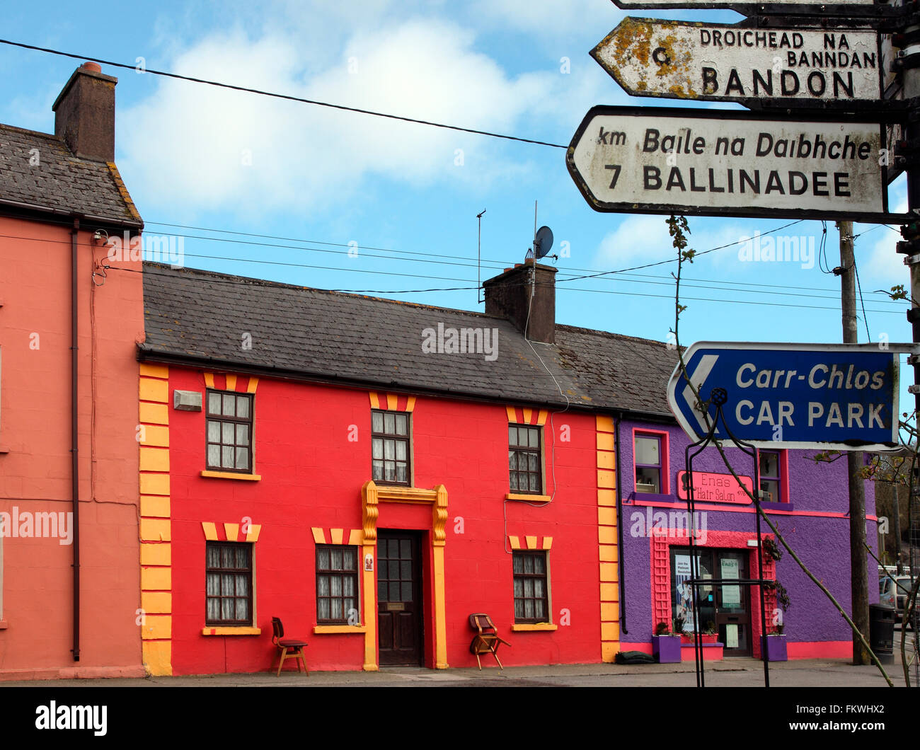 Signposts and coloured facades in village of Ballinspittle in County Cork Stock Photo