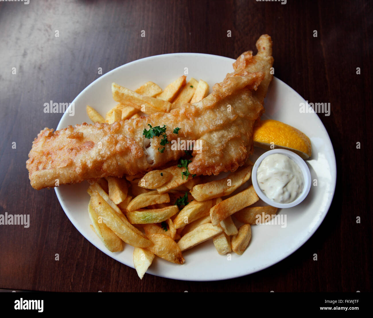 Battered cod and chips served at Dino's fish restaurant, Kinsale Stock Photo