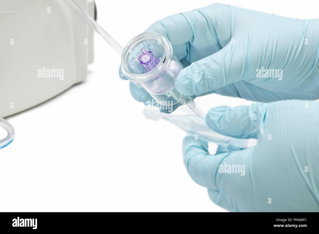 Nurse prepares medication cup for inhalation therapy with medical