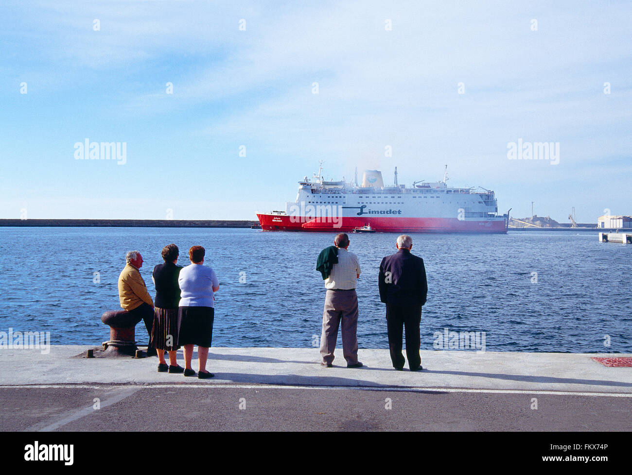 Mature people at the harbour, watching a ship departure. Almeria, Spain. Stock Photo