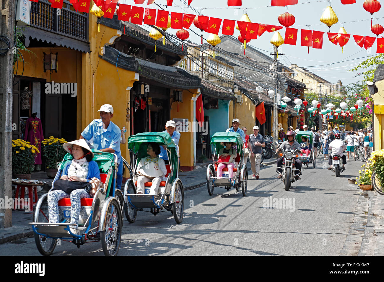 Colorful lanterns and cyclos on street, Hoi An, Vietnam Stock Photo