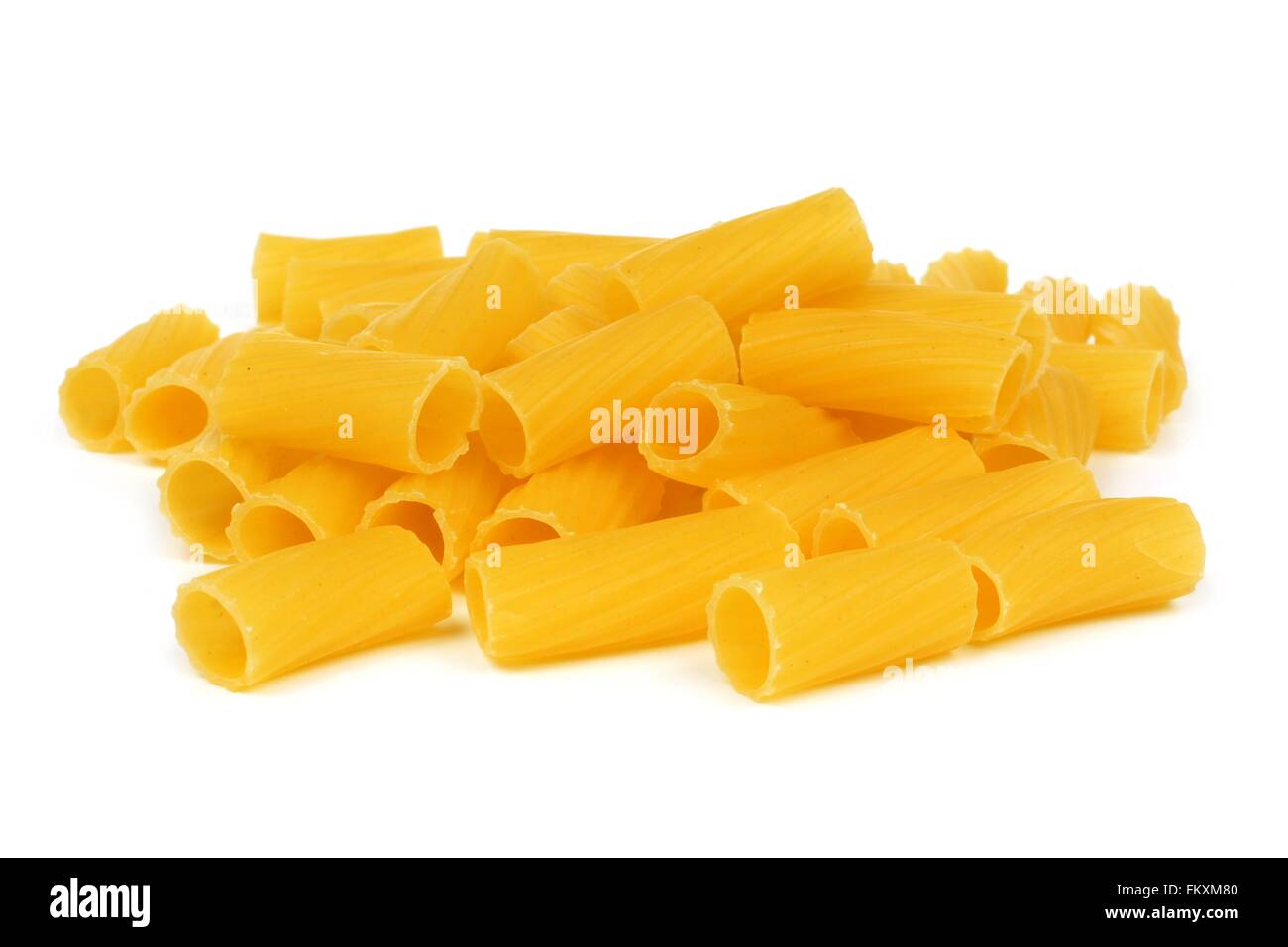 Pile of uncooked dry rigatoni pasta isolated on a white background Stock Photo