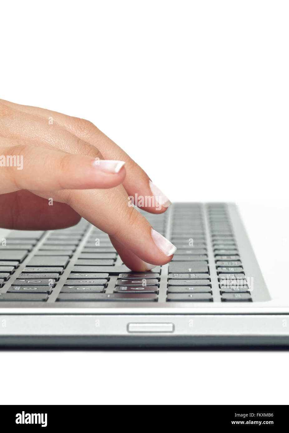 Macro photo of female hand typing on laptop Stock Photo