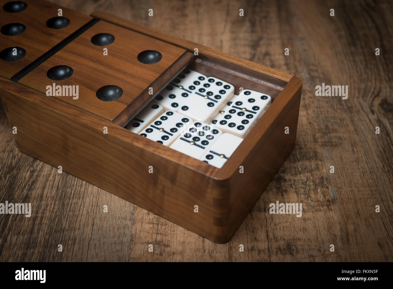 Set of dominos in a wooden box Stock Photo