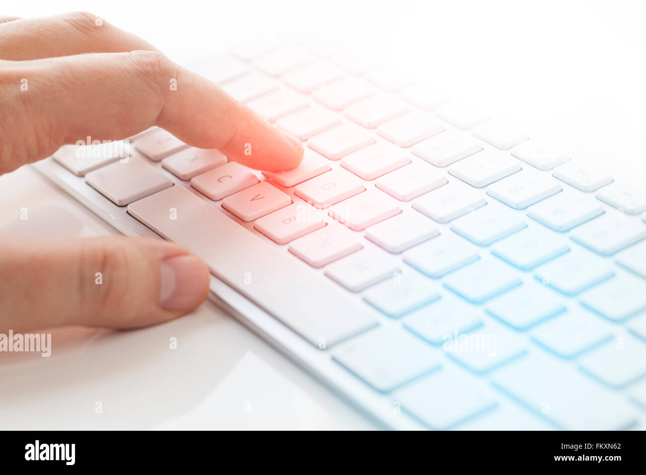 Male hand typing on computer keyboard Stock Photo