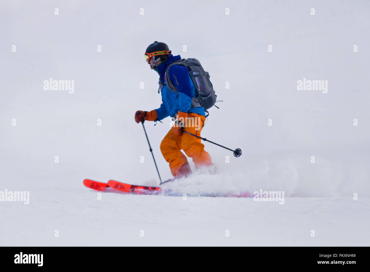 Man skiing with snow cloud Stock Photo