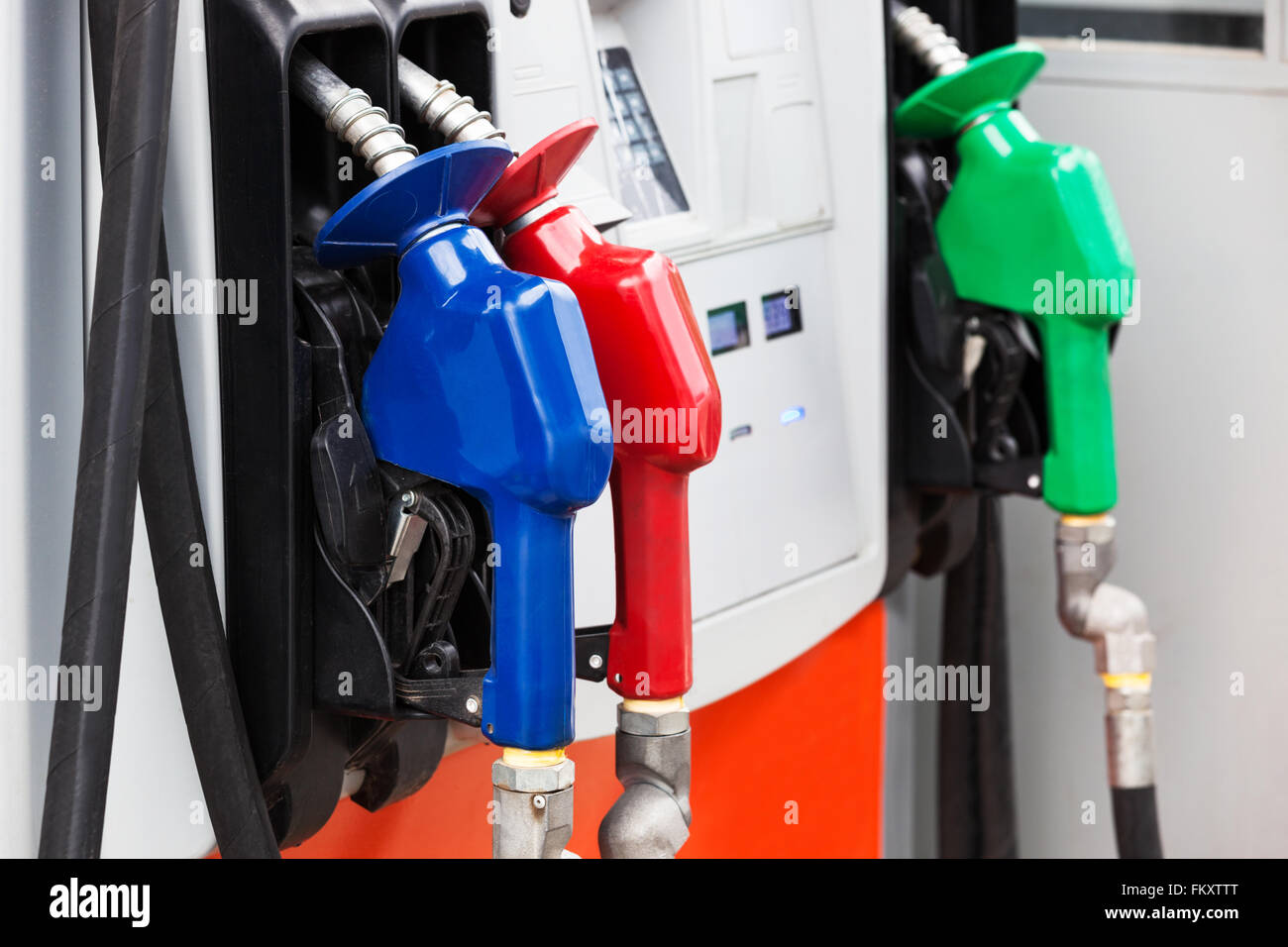 three gas hoses on a modern gas station Stock Photo Alamy