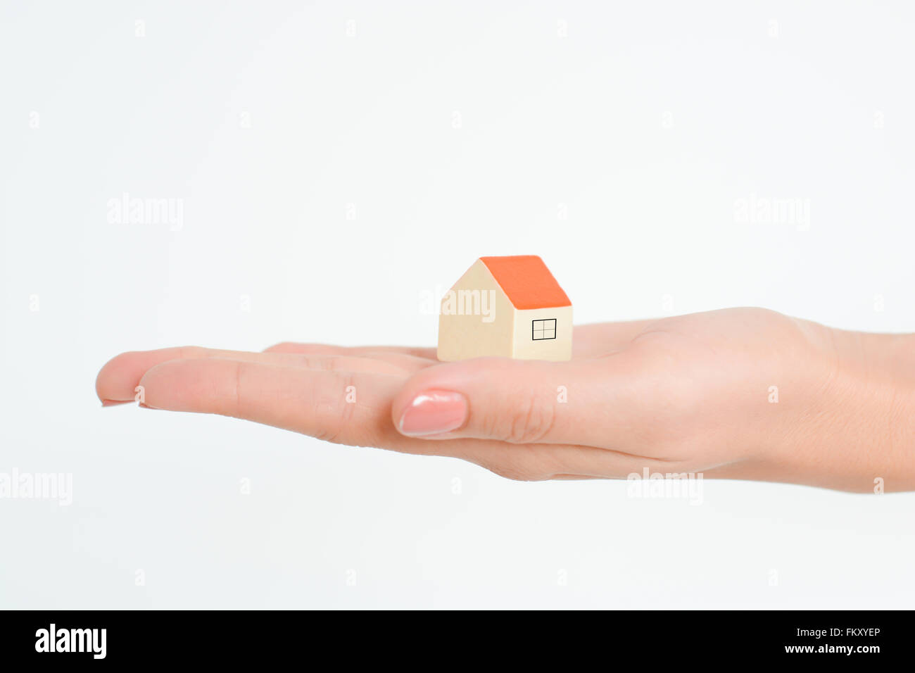 Close-up of woman's hands holding a small model house Stock Photo - Alamy