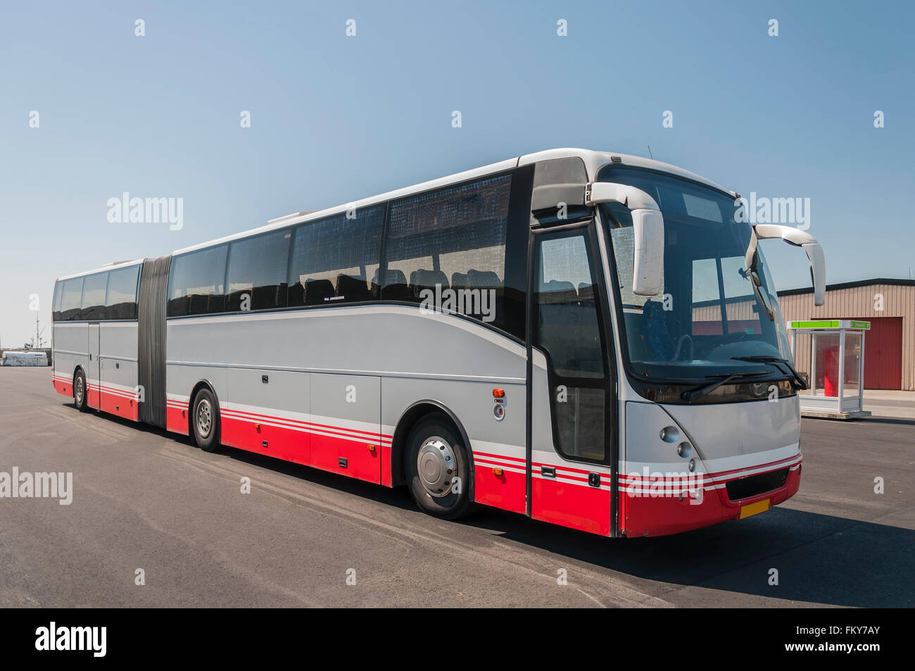 A grey and red travel tour coach parked and awaiting tourists. Stock Photo