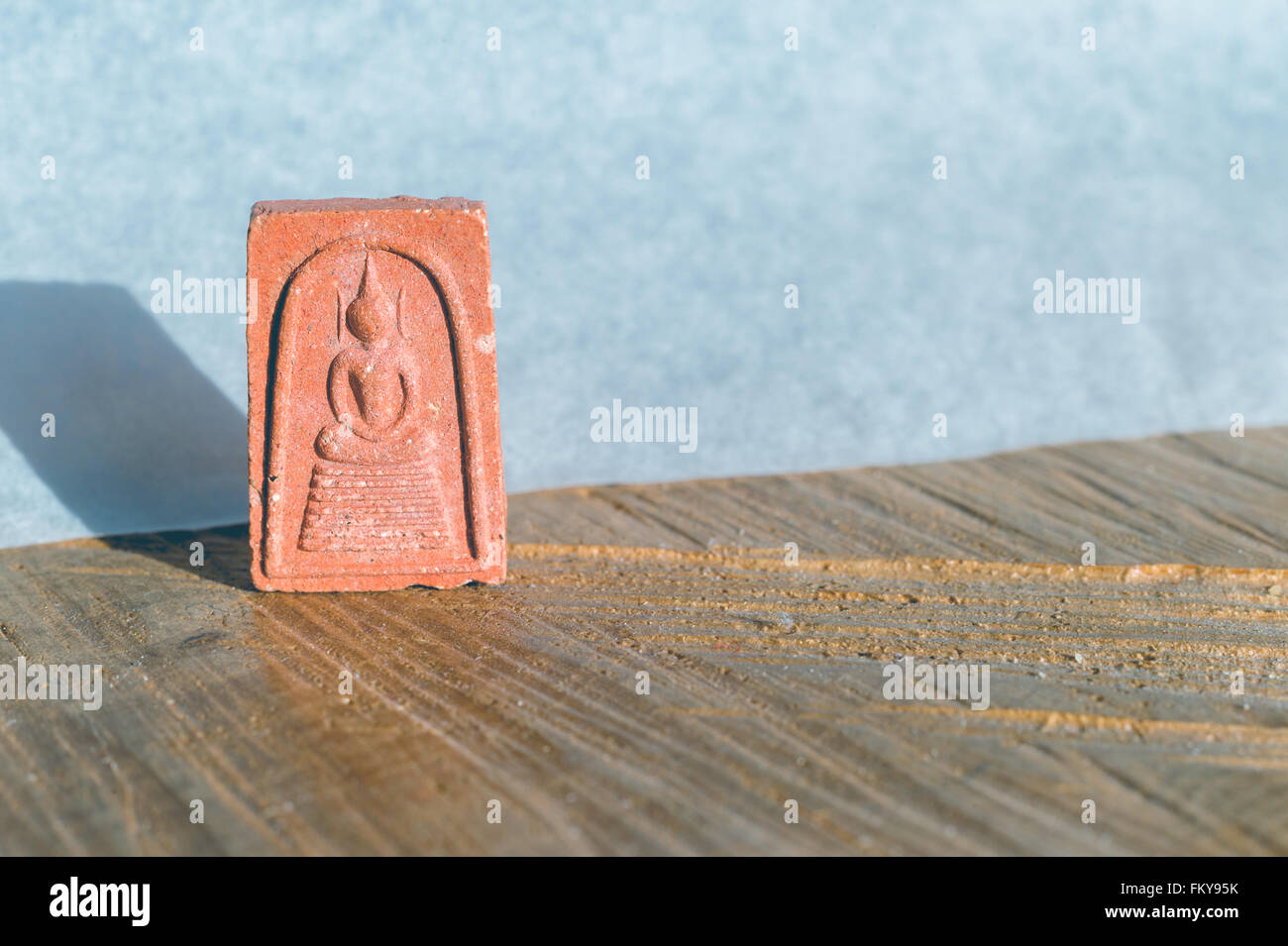 Close-up of a Pra Somdej Buddha clay amulet with copyspace Stock Photo