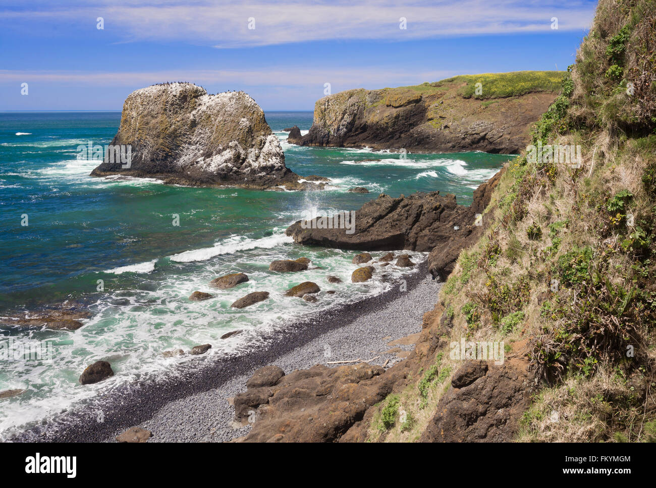 A typical scene on a sunny day at the rugged Oregon coast at Yaquina Cove, by the lighthouse in Newport. Stock Photo