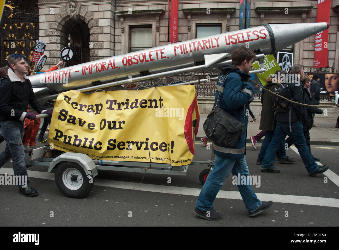 CND, anti Trident demo with model of missile with "Immoral,obsolete, useless", and "Scrap trident, Save our public services" Stock Photo