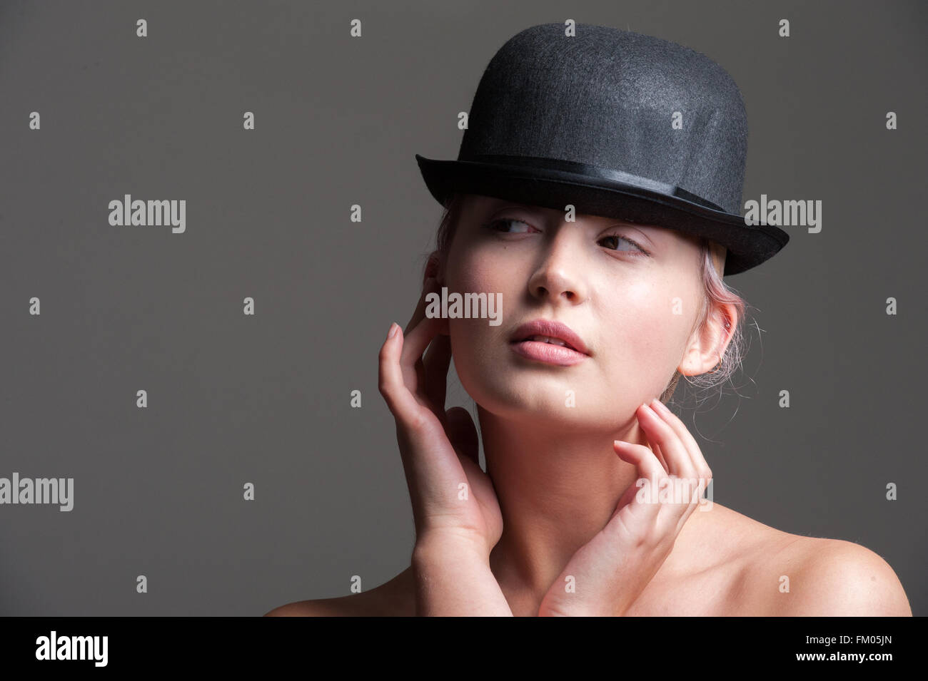 young lady posing in a black bowler hat Stock Photo - Alamy