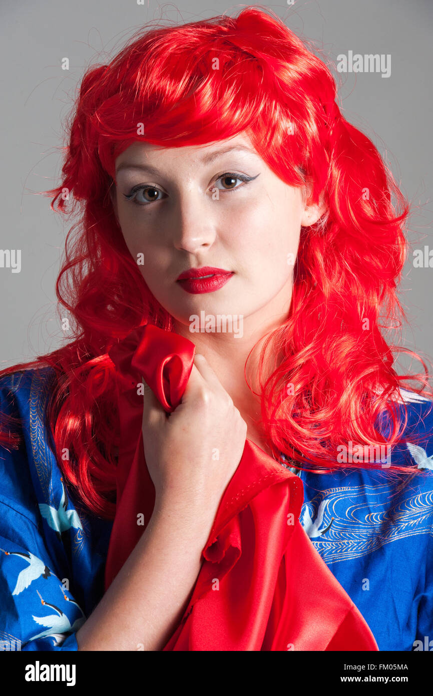 young lady with red hair in blue kimono Stock Photo