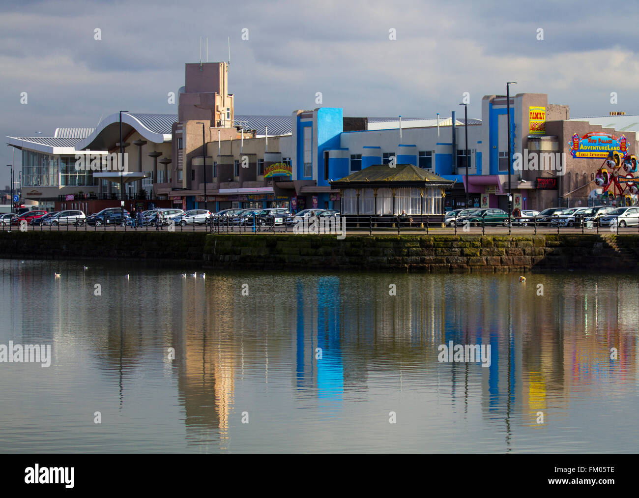 The seafront at New Brighton, Wallasey, UK with buildings reflected in