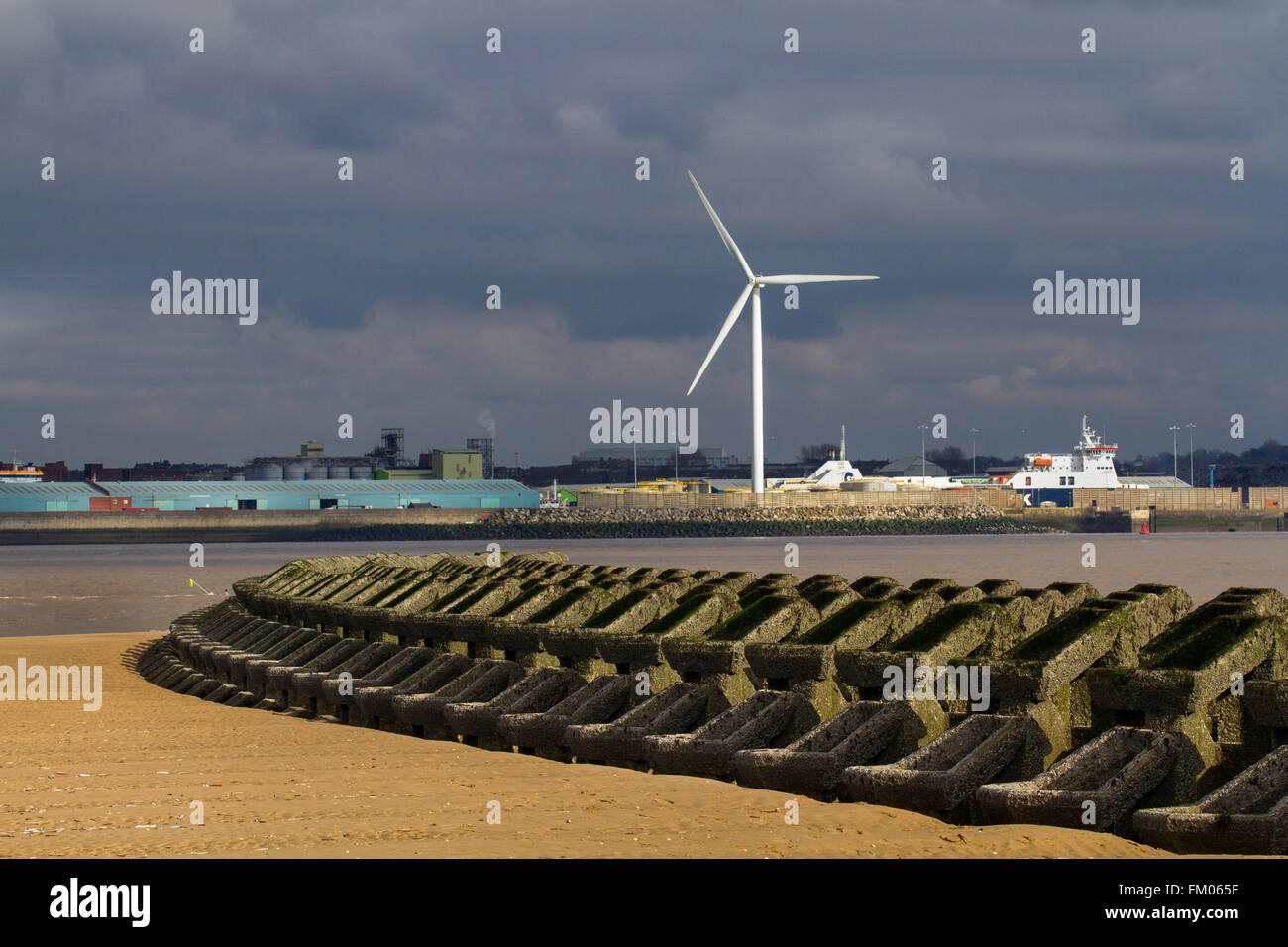 Low water exposes the Sea defences, showing a concrete pre-formed groyne installed to calm the waters at the estuary on the River Mersey, New Brighton, Wallasey, Wirral, Merseyside, UK Stock Photo