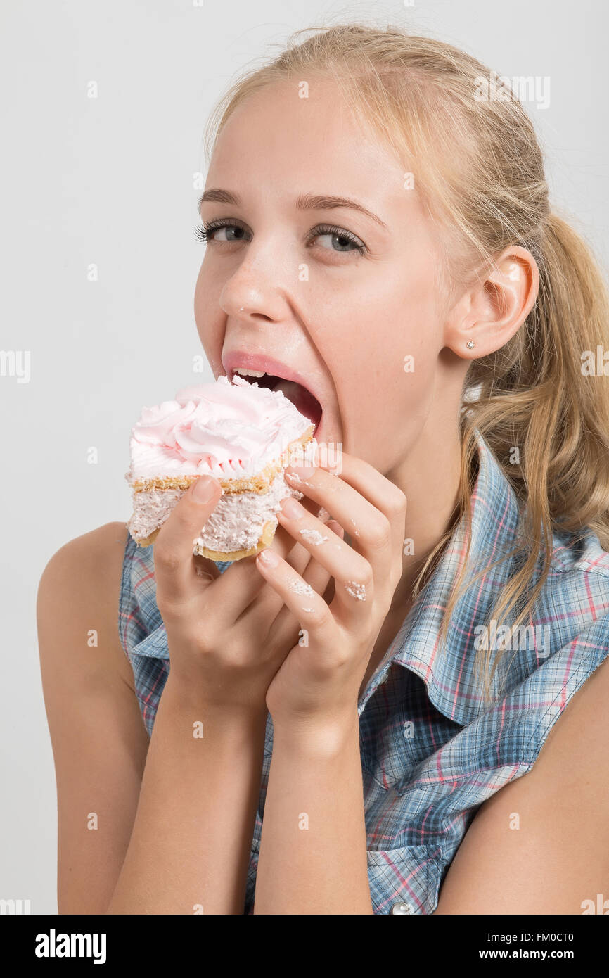 fun pretty girl with sponge cake on white background Stock Photo
