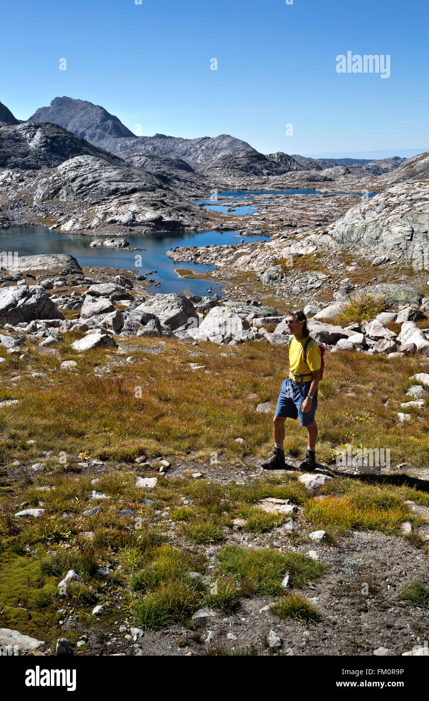 WY01274-00...WYOMING - Hiker above Indian Basin on the trail to Indian Pass in the Wind River Range. Stock Photo