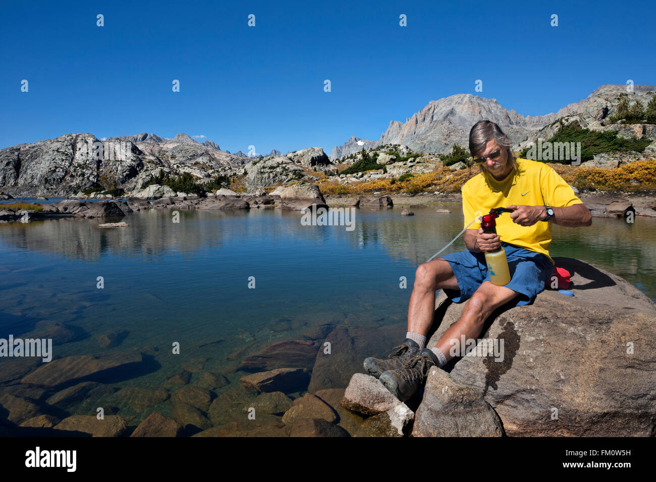 WYOMING - Using a pump filter to purify drinking water from Island Lake in the Bridger Wilderness area of the Wind River Range. Stock Photo