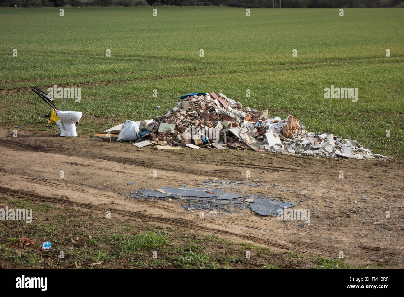 Rubbish dumped by the side of a footpath in the English countryside near Dinnington, Rotherham. Stock Photo