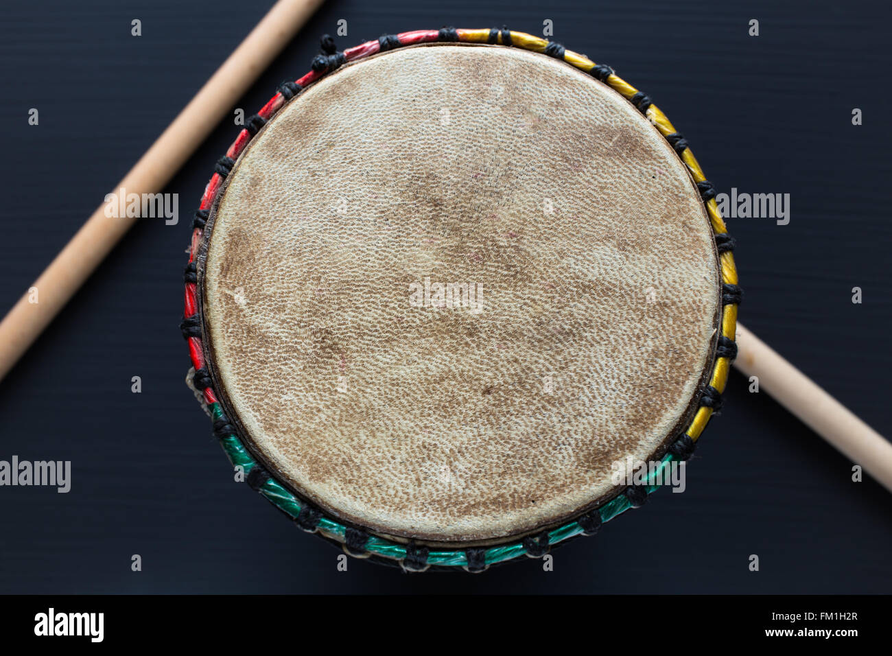 Djembe with drum sticks Stock Photo