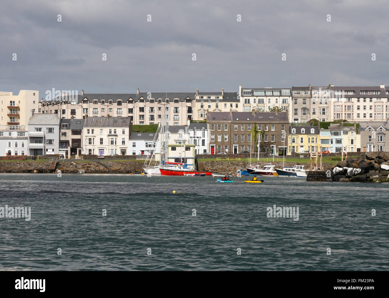 Houses and overlooking boats in Portrush Harbour at Portrush, County Antrim