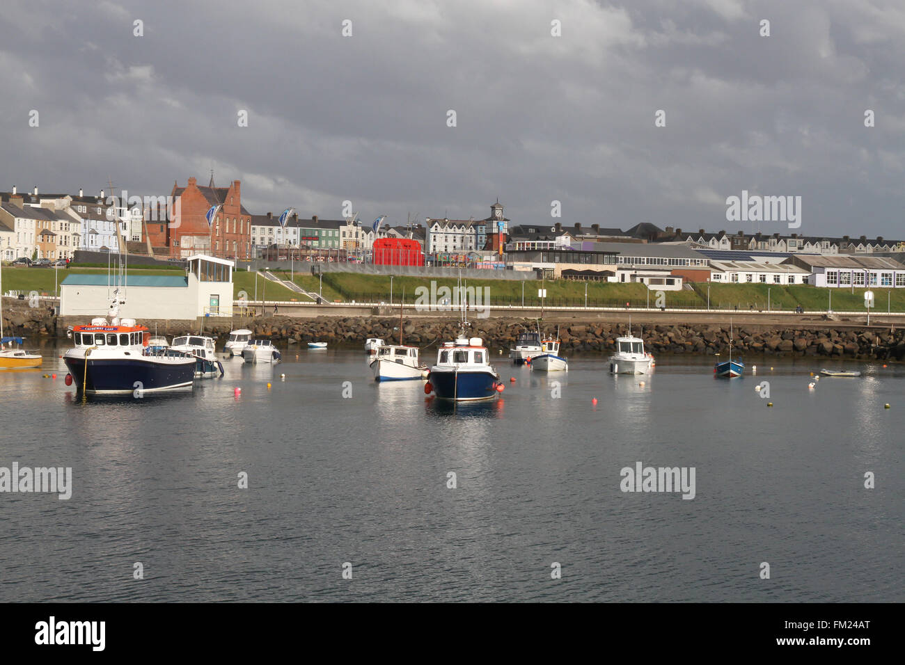 Houses and overlooking boats in Portrush Harbour at Portrush, County Antrim