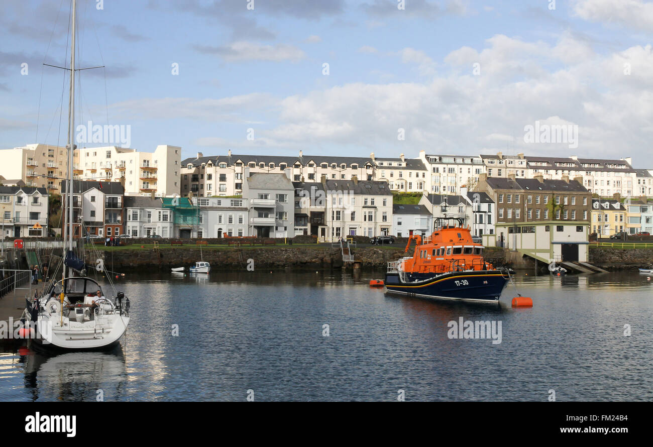 Seafront houses and accommodation overlooking boats in Portrush Harbour at Portrush, County Antrim, Northern Ireland Stock Photo