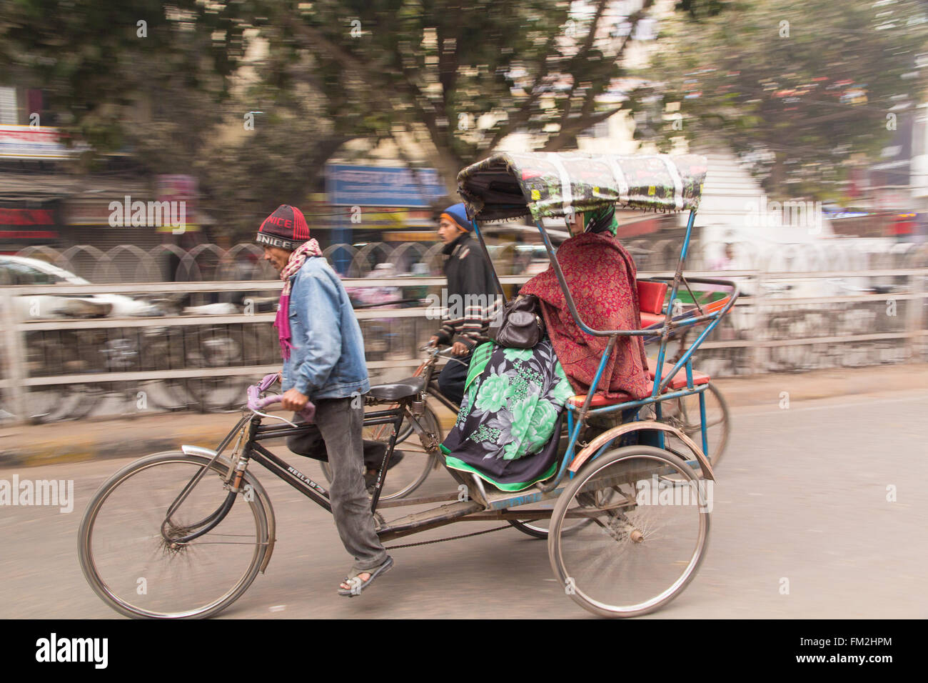 India, New Delhi,pedicab, rickshaw speeds down the narrow streets. Stock Photo